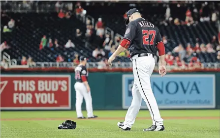  ?? ASSOCIATED PRESS FILE PHOTO ?? In a surprising action, Major League Baseball’s Washington Nationals demoted pitcher Shawn Kelley when he threw his glove to the ground. He was upset with himself after a batter hit a home run. Above, Kelley walks to pick up his glove.