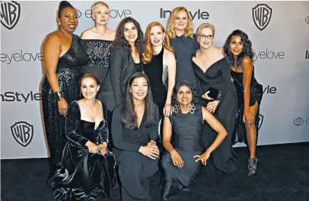  ??  ?? Making a statement: Tarana Burke, back left, with Michelle Williams, Meryl Streep and other actresses and activists in black at the Golden Globes