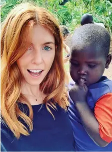  ??  ?? Storm: Stacey Dooley’s photo with Ugandan boy