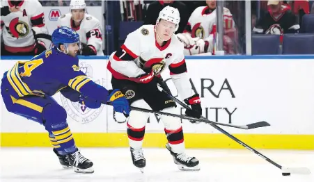  ?? JEFFREY T. BARNES, THE ASSOCIATED PRESS ?? Senators winger Brady Tkachuk looks to pass while under pressure from Sabres centre Dylan Cozens during the second period in Buffalo on Wednesday.