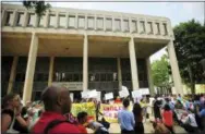  ?? BRIAN A. POUNDS/HEARST CONNECTICU­T MEDIA VIA AP ?? People hold a rally outside the Federal Courthouse in Bridgeport, Conn. on Wednesday, July 11, 2018. Lawyers for two immigrant children detained in Connecticu­t after being separated from their parents at the U.S.-Mexico border asked a federal judge on...