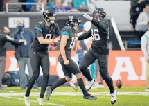  ?? MATT DUNHAN/AP ?? Jags kicker Matthew Wright, center, celebrates after hitting the game-winning field goal against the Dolphins on Sunday in London.