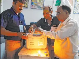  ?? Rajesh Kumar Singh The Associated Press ?? Election officers seal an electronic voting machine Sunday in Varanasi, India.