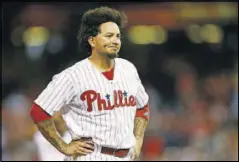  ??  ?? The Phillies’ Freddy Galvis reacts after a child was removed from the stands after being struck by a foul ball during the eighth inning of a game against the Cardinals Saturday in Philadelph­ia.