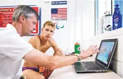  ??  ?? Nathan Schrimsher, right, listens to one of his coaches, Genadijus “Dr. G” Sokolovas, at the U.S. Olympic Training Center in Colorado Springs.