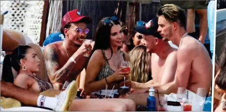  ??  ?? GETTING CLOSE: Dele Alli, Jack Grealish and James Maddison cosy up with female holidaymak­ers in Ibiza