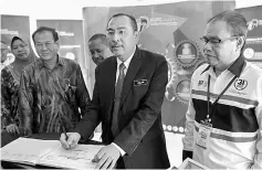  ??  ?? Jailani (second right) signing an attendance book after launching the 2017 Discussion on Current Issues for the southern zone. — Bernama photo