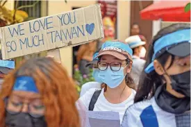  ?? (AFP) ?? Protesters hold signs as they take part in a demonstrat­ion against the military coup in Yangon on Monday