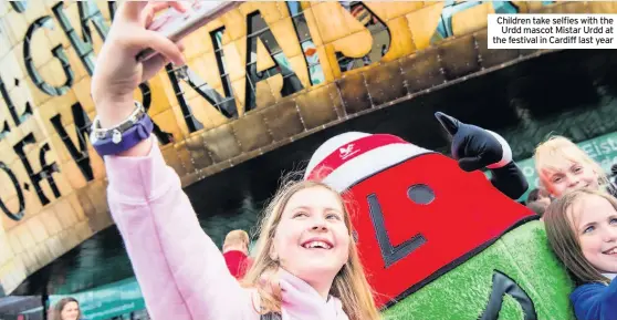  ??  ?? Children take selfies with the Urdd mascot Mistar Urdd at the festival in Cardiff last year
