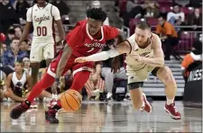  ?? MARK STOCKWELL — THE ASSOCIATED PRESS ?? North Carolina State’s Jarkel Joiner, left, and Boston College’s Mason Madsen chase a loose ball during Saturday’s clash at the Conte Forum. BC lost 92-62.