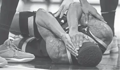  ?? GRACE HOLLARS/INDYSTAR ?? Suns guard Bradley Beal lies on the court after being elbowed in the nose during Friday’s game at Gainbridge Fieldhouse in Indianapol­is. Indiana defeated Phoenix 133-131.