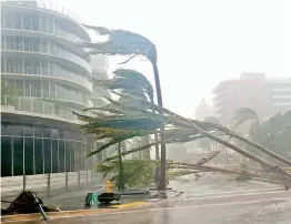  ?? — AP ?? Palm trees lie strewn across the road as Hurricane Irma passed by Miami Beach, Florida, last week leaving a trail of death and destructio­n. Seven million people in the Southeast were warned to evacuate, including 6.4 million in Florida alone.