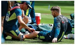  ?? GETTY IMAGES ?? Bruised: Warner is checked out by physio David Beakley yesterday