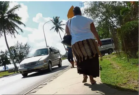 ?? — AFP ?? Weighing in on the issue: Pedestrian­s walking along a sidewalk in Nuku’alofa in Tonga.