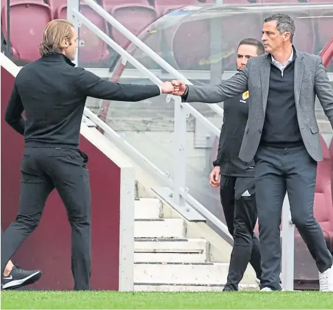  ??  ?? TO CELEBRATE OR APPRECIATE: Robbie Neilson and Jack Ross at the capital city derby at Tynecastle.