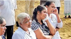  ??  ?? Feeling the pain: Mourners at a funeral in Katuwapiti­ya