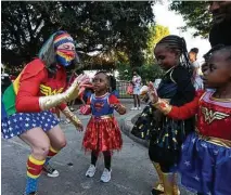  ?? Yi-Chin Lee / Staff photograph­er ?? Trick-or-treating, a normally outdoor event, is mostly COVID-safe. However, be cautious when handing out candy.