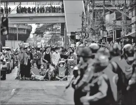  ?? AFP ?? WON’T BUDGE: Riot police gather as protesters take part in a demonstrat­ion against the military coup in Yangon on Saturday.