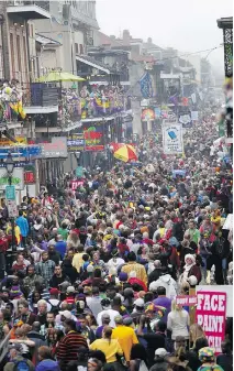  ??  ?? Throngs of revellers on Bourbon Street. Some of the most elaborate Mardi Gras costumes go on display at the annual Bourbon Street awards.