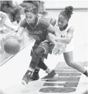  ??  ?? Northwest Classen’s Joy Gunn tries to steal the ball from Millwood’s Jada Wilson during Tuesday’s girls high school basketball game between Northwest Classen and Millwood at Northwest Classen High School.