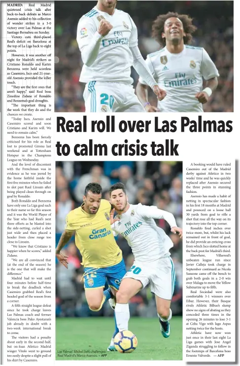 ?? — AFP ?? Las Palmas’ Michel (left) challenges Real Madrid’s Marco Asensio.