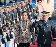  ?? REUTERS ?? Indonesian President Joko Widodo reviews the honour guards upon arrival at Villamor air base in Pasay city, Manila, yesterday.