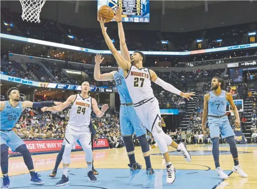  ?? Brandon Dill, The Associated Press ?? Nuggets guard Jamal Murray shoots against Memphis Grizzlies center Marc Gasol in the first half Wednesday night.
