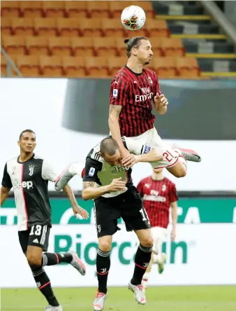  ??  ?? AC Milan’s Zlatan Ibrahimovi­c (top) in action with Juventus’ Leonardo Bonucci during their Serie A football match.