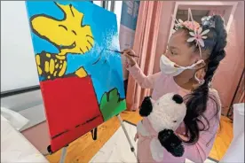  ?? AP-Mary Altaffer ?? Kaley Williams, 8, paints a panel of a “Peanuts” mural that will be placed in the outpatient pediatric floor of One Brooklyn Health at Brookdale Hospital in the Brooklyn borough of New York.