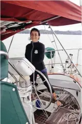  ??  ?? The author is all smiles at the helm of her first cruising boat, a Young Sun 35.