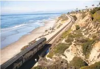  ?? ANA RAMIREZ U-T FILE ?? An Amtrak Pacific Surfliner train passes through Del Mar in November. A fence is planned to restrict pedestrian crossing.