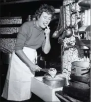  ?? PAUL CHILD — THE SCHLESINGE­R LIBRARY, RADCLIFFE INSTITUTE, HARVARD UNIVERSITY VIA AP ?? In this 1950s photo provided by Thames and Hudson, is Julia Child in the kitchen in France that is in the exhibit, “France is a Feast - The Photograph­ic Journey of Paul and Julia Child,” at the Napa Valley Museum in Yountville The exhibit features...