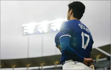  ?? ASHLEY LANDIS — THE ASSOCIATED PRESS ?? Dodgers designated hitter Shohei Ohtani stands as the national anthem plays before a spring training baseball game against the Angels in Los Angeles on Sunday.