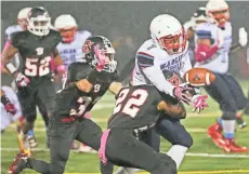  ?? MICHAEL SEARS/MILWAUKEE JOURNAL SENTINEL ?? Milwaukee Marshall's Martez Allen-Carr can’t secure a reception as heis tackled by Bay View’s Brandon Strauss on Friday night.