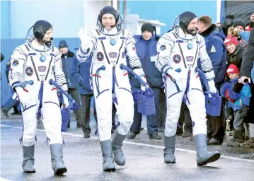  ??  ?? Internatio­nal Space Station (ISS) crew members (from right) David Saint-Jacques, Oleg Kononenko and Anne McClain walk after donning space suits shortly before their launch at the Baikonur Cosmodrome. — Reuters photo