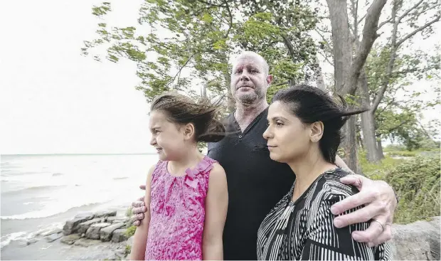  ?? GLENN LOWSON / POSTMEDIA ?? Gerald Major with his daughter Tessa, five, and wife Anna at their Oakville, Ont. home. The right treatment program for him has dramatical­ly improved his quality of life.