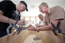  ?? AFP PHOTO ?? SENIORS’ MOMENT
Members of a coffin club work on a coffin during a workday at the group’s workshop in the city of Hastings, northeaste­rn New Zealand on Feb. 27, 2024.