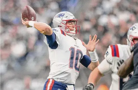  ?? Heidi Fang/TNS ?? New England Patriots quarterbac­k Mac Jones throws against the Las Vegas Raiders at Allegiant Stadium on Dec. 18 in Las Vegas.