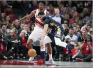  ?? RANDY L. RASMUSSEN - THE ASSOCIATED PRESS ?? Portland Trail Blazers forward Ed Davis, left, forces the ball loose from New Orleans Pelicans forward Anthony Davis during the second half in Game 1 of an NBA first-round playoff series, Saturday, in Portland, Ore.