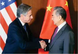  ?? AFP PHOTO ?? WE MEET AGAIN
United States Secretary of State Antony Blinken (left) and Chinese Foreign Minister Wang Yi shake hands during the 60th Munich Security Conference in the city of Munich, southern Germany on Friday, Feb. 16, 2024.