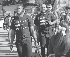  ?? BRYAN TERRY/THE OKLAHOMAN ?? OU’s Kennedy Brooks, left, and Jeremiah Hall (27) arrive before last Saturday’s game against TCU wearing T-shirts in support of Julius Jones.