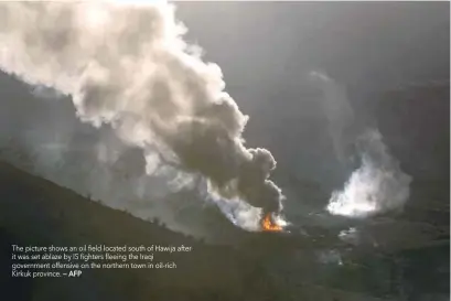  ?? — AFP ?? The picture shows an oil field located south of Hawija after it was set ablaze by IS fighters fleeing the Iraqi government offensive on the northern town in oil-rich Kirkuk province.