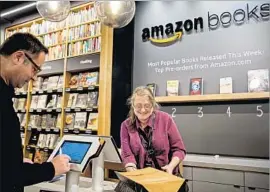  ?? Stephen Brashear Getty Images ?? AMAZON’S New York store is near the headquarte­rs of publishers Penguin Random House, Hachette and Simon & Schuster. Above, the firm’s Seattle bookstore.