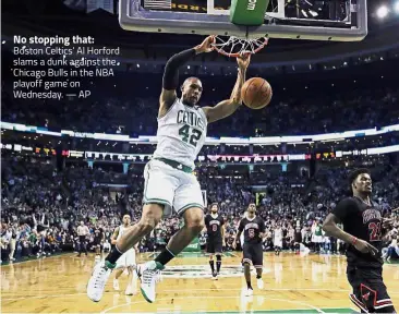  ?? — AP ?? No stopping that: Boston Celtics’ Al Horford slams a dunk against the Chicago Bulls in the NBA playoff game on Wednesday.