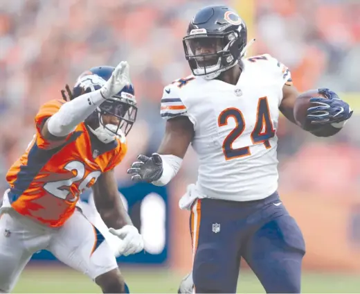  ?? JACK DEMPSEY/AP ?? Running back Jordan Howard eludes Broncos defensive back Bradley Roby. Howard rushed for 32 yards on nine carries in his preseason debut.