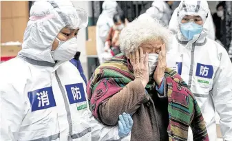  ?? Xiong Qi / Xinhua / Tribune News Service ?? A cured coronaviru­s patient weeps as she leaves a rehabilita­tion center in Wuhan, China, this month. Convalesce­nt plasma from such patients might save the lives of others who are infected.