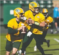  ?? IAN KUCERAK ?? Elks passer Taylor Cornelius, centre, runs through drills with the team's other QBS at training camp on Sunday at Commonweal­th Stadium. Cornelius is among the front-runners for the job.