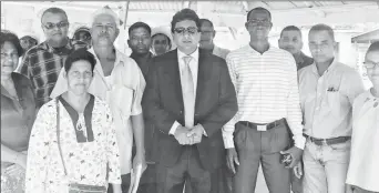  ??  ?? Attorney at law Anil Nandlall (in suit) with some of the aggrieved rice farmers shortly after the legal proceeding­s against them were withdrawn yesterday. Also in the photo (second from right) is PPP/C Member of Parliament Dharamkuma­r Seeraj.