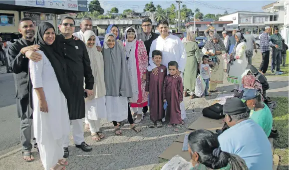  ?? Photo: Simione Haravanua ?? Attorney-General Aiyaz Sayed-Khaiyum (standing tenth from left), Minister for Industry, Trade and Tourism Faiyaz Koya (standing fourth from left), and FBC chief executive officer Riyaz Sayed-Khaiyum (standing left), with family and friends after the Eid prayers in Suva on June 16, 2018.