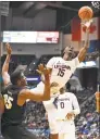  ?? Jessica Hill / Associated Press ?? UCF’s Collin Smith (35) fouls UConn’s Sidney Wilson during the first half on Saturday.